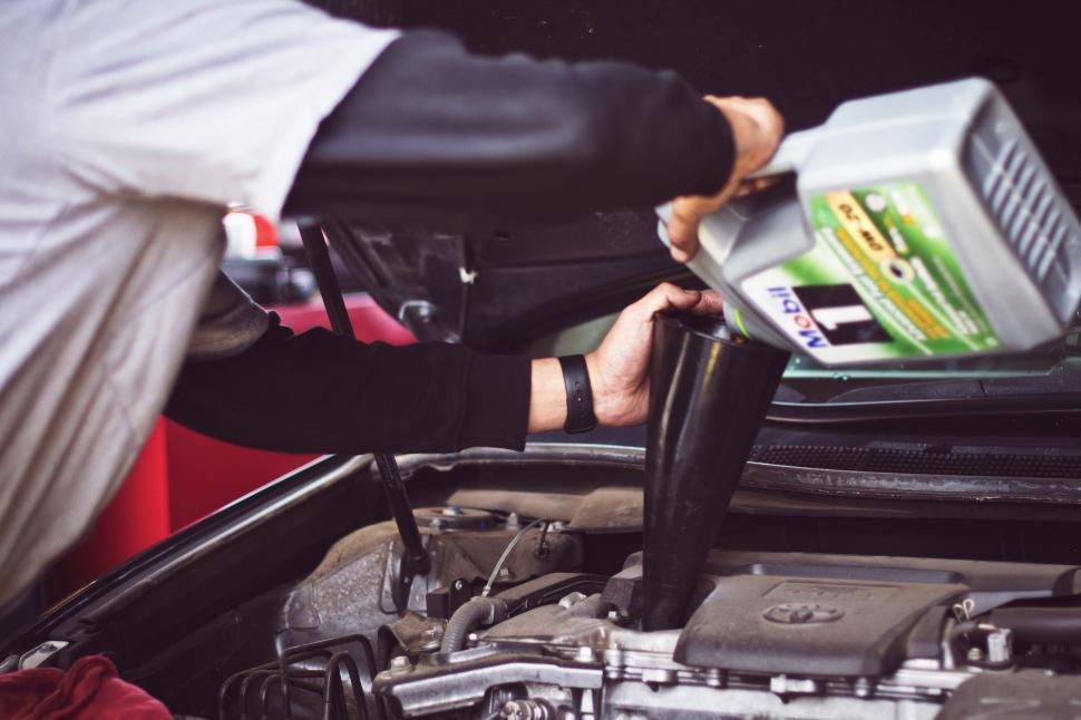 Free Stock Photo of Man Working on Car Engine