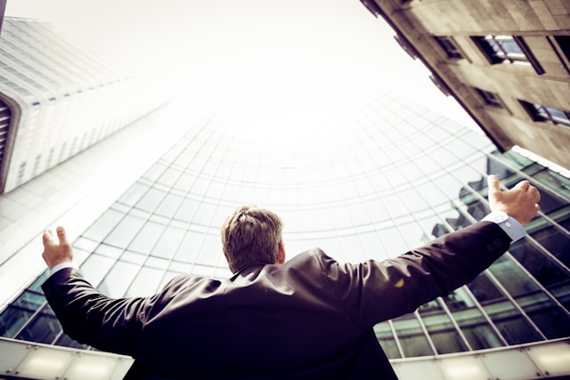 low angle photography of man in the middle of buildings