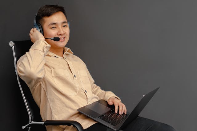 a man in brown button up long sleeve shirt using a laptop