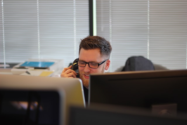 man using ip phone inside room