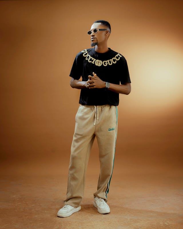 stylish man posing against warm studio backdrop